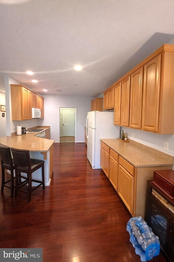 14137 Cedar Run Road Culpeper, VA 22701 - Photo 18 of 30 a kitchen with stainless steel appliances granite countertop a sink cabinets and wooden floor