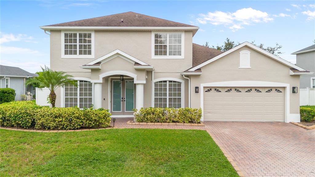 3333 Atmore Terrace Ocoee, FL 34761 - Photo 1 of 37 a front view of a house with garden
