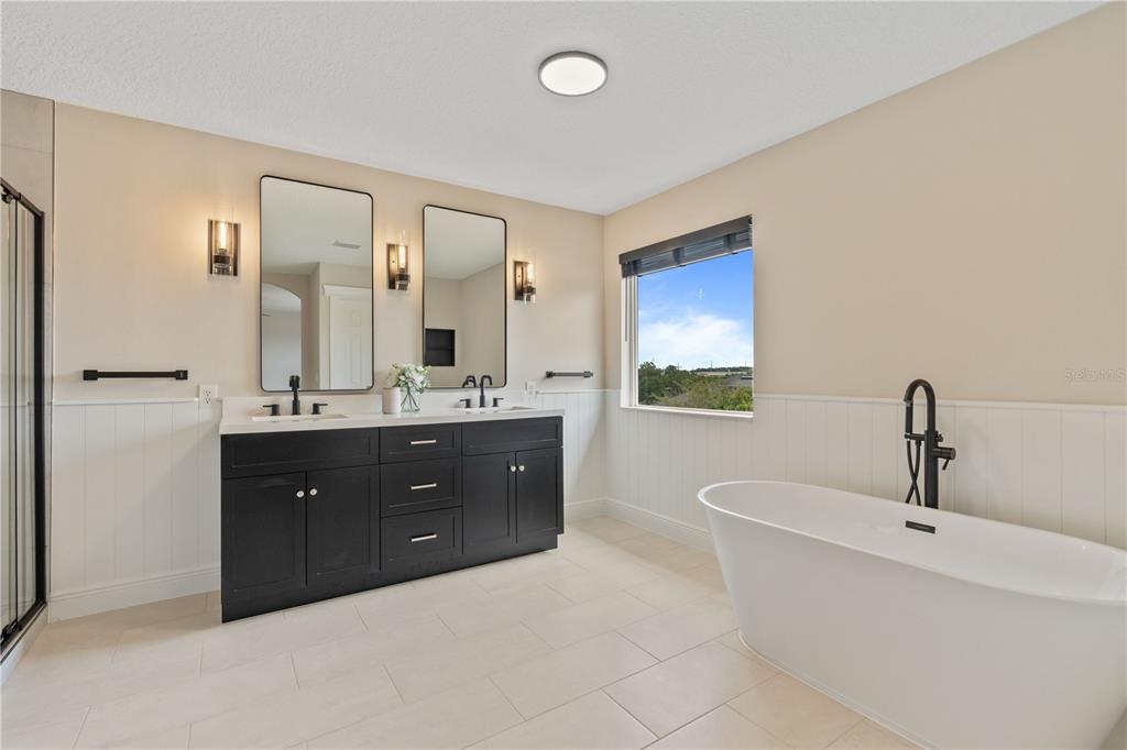 3333 Atmore Terrace Ocoee, FL 34761 - Photo 18 of 37 a bathroom with a double vanity sink and mirror