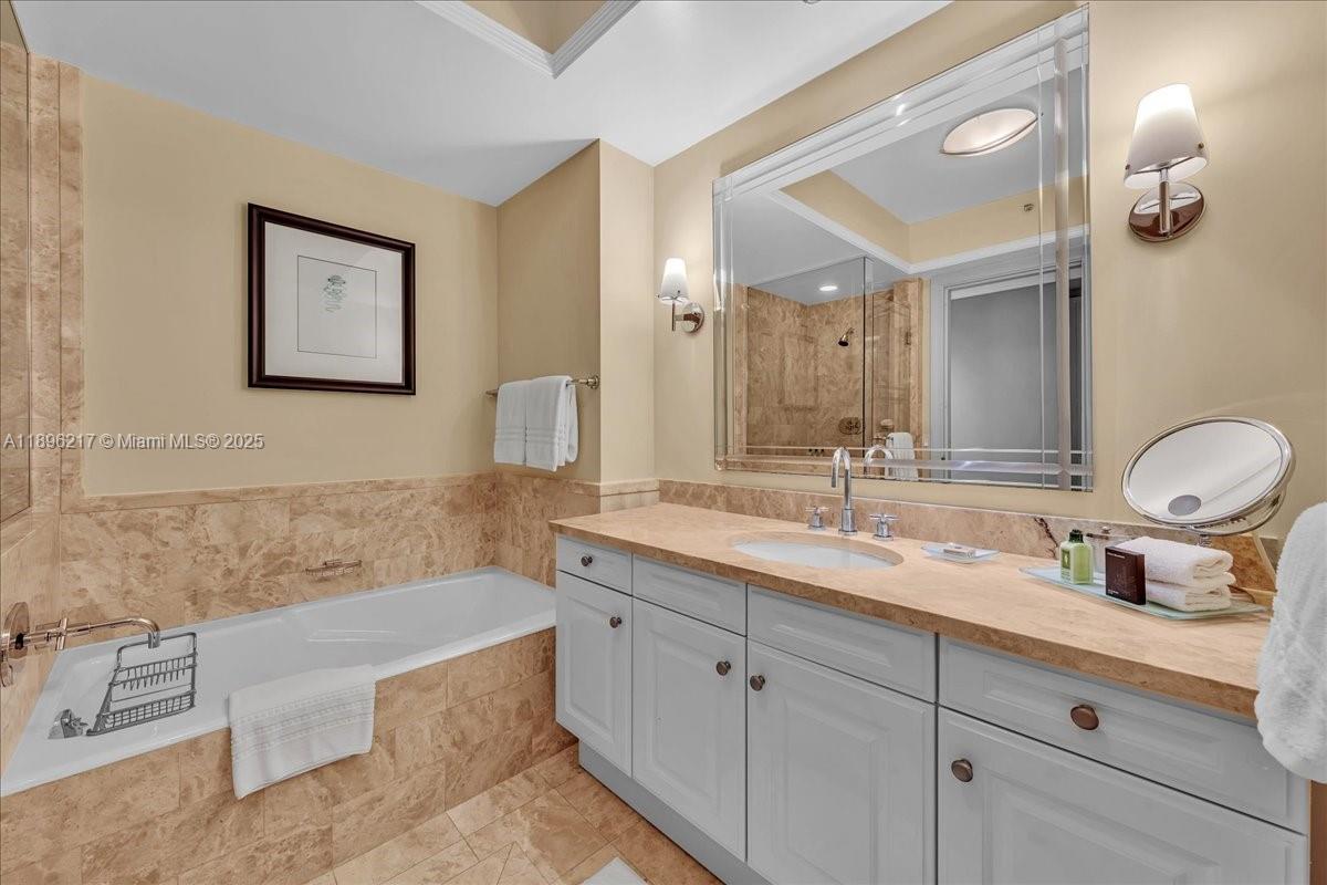 1435 Brickell Avenue, Unit 3603 Miami, FL 33131 - Photo 15 of 26 a bathroom with a tub double sink and mirror