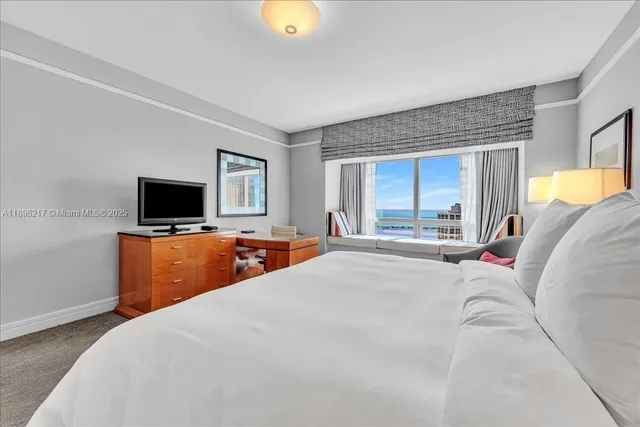 a bedroom with a bed and a lamp