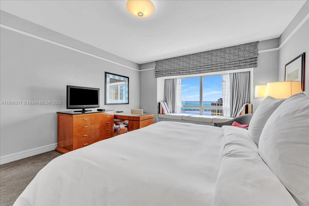 1435 Brickell Avenue, Unit 3603 Miami, FL 33131 - Photo 17 of 26 a bedroom with a bed and a flat screen tv