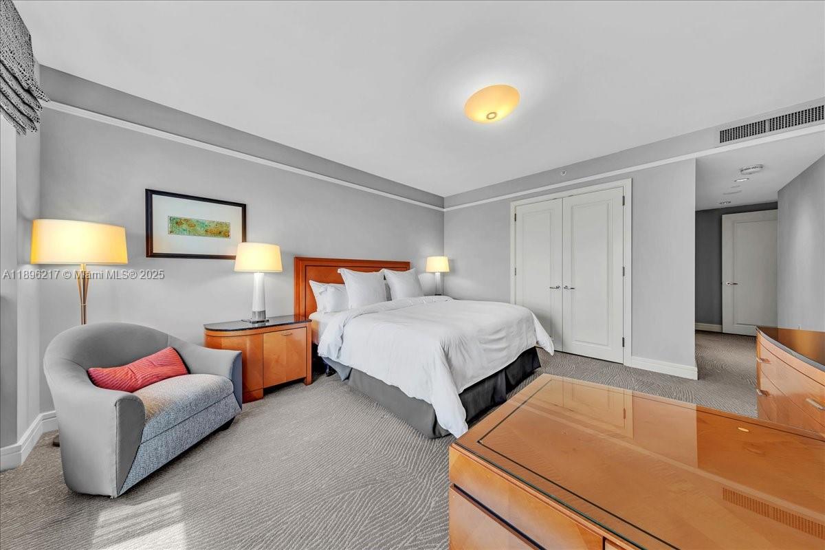 1435 Brickell Avenue, Unit 3603 Miami, FL 33131 - Photo 19 of 26 a bedroom with bed and a couch