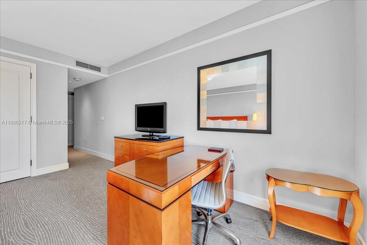 1435 Brickell Avenue, Unit 3603 Miami, FL 33131 - Photo 20 of 26 a room with furniture and a flat screen tv