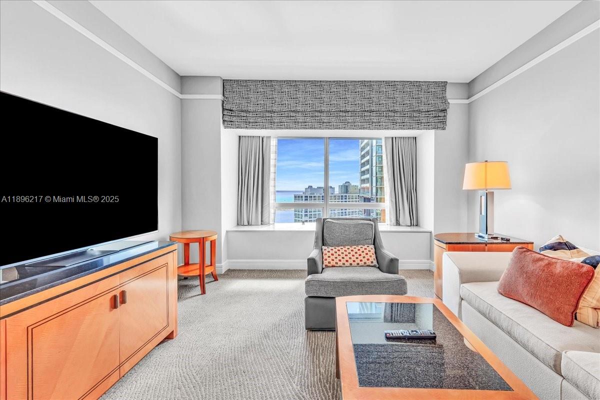 1435 Brickell Avenue, Unit 3603 Miami, FL 33131 - Photo 3 of 26 a living room with furniture and a flat screen tv