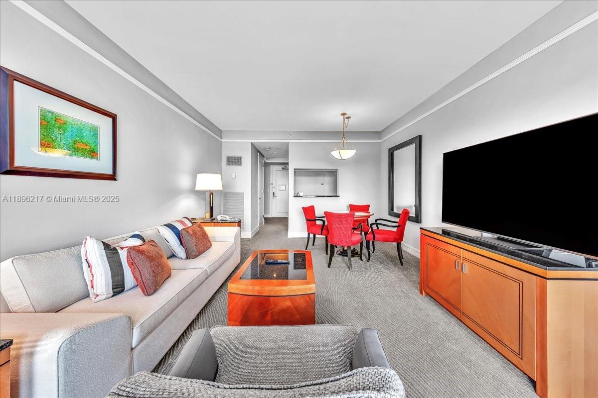 1435 Brickell Avenue, Unit 3603 Miami, FL 33131 - Photo 5 of 26 a living room with furniture and a flat screen tv