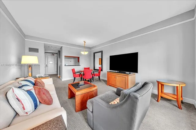 a living room with a large window and a table