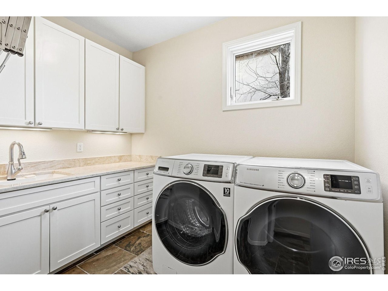 4840 6th Street Boulder, CO 80304 - Photo 39 of 43 A large laundry room is on the main floor and has a utility sink, counter tops for folding clothes and storage.