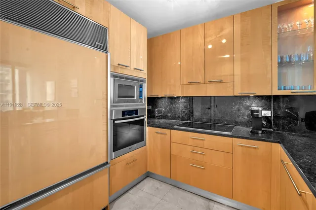 a view of a kitchen sink and a washer dryer
