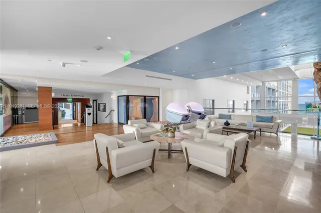 a living room with patio furniture and a potted plant