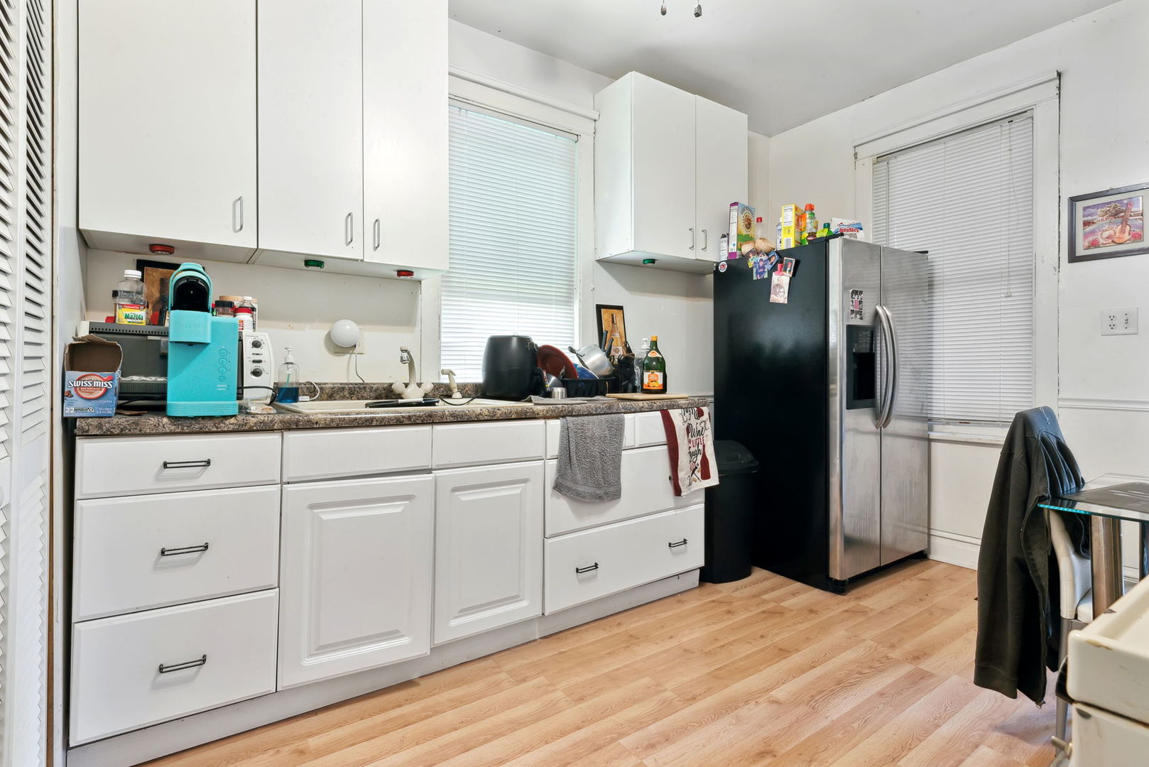 4411 West Haddon Avenue Chicago, IL 60651 - Photo 12 of 21 a kitchen with white cabinets and refrigerator