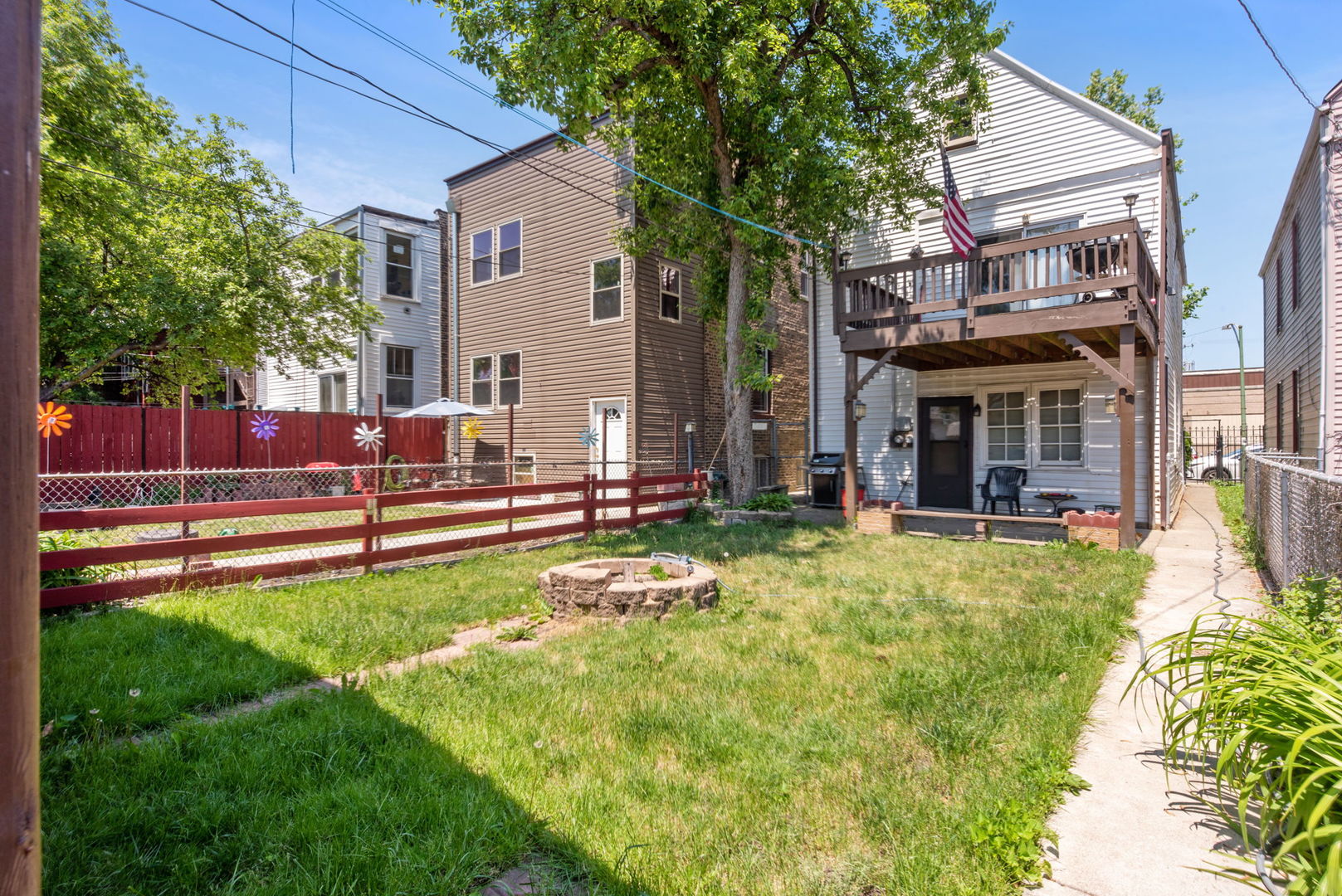 4411 West Haddon Avenue Chicago, IL 60651 - Photo 20 of 21 a view of a house with a yard patio and a small yard