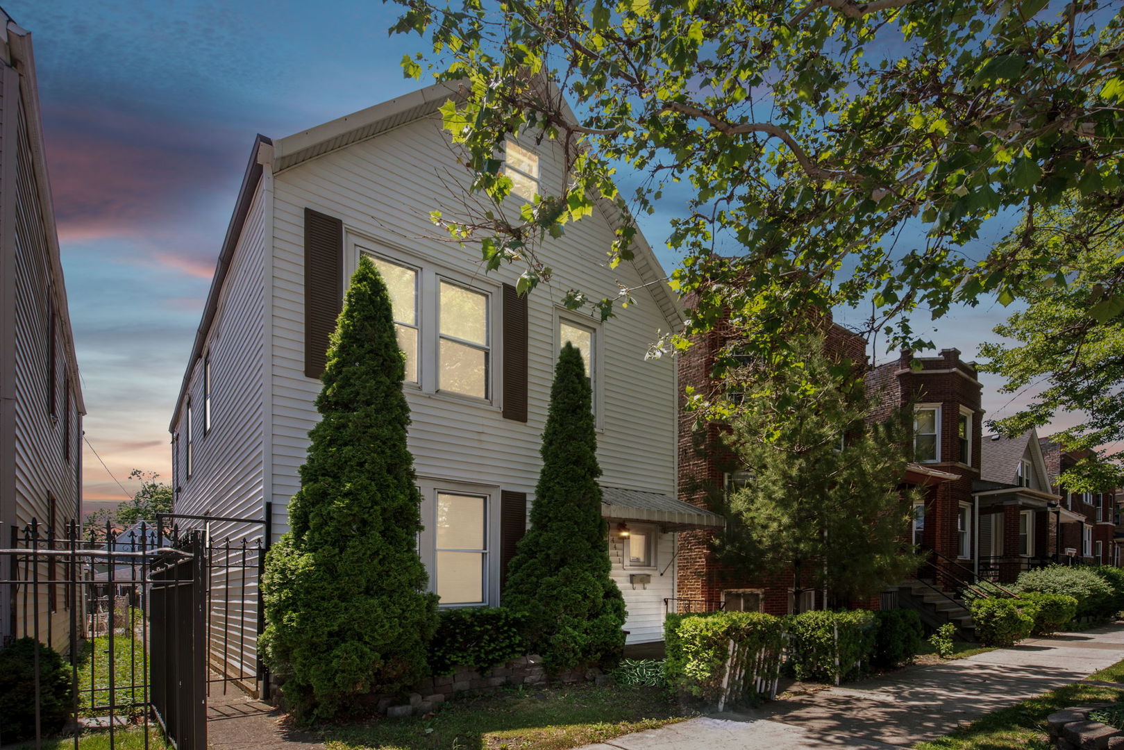 4411 West Haddon Avenue Chicago, IL 60651 - Photo 21 of 21 a front view of a house with a garden