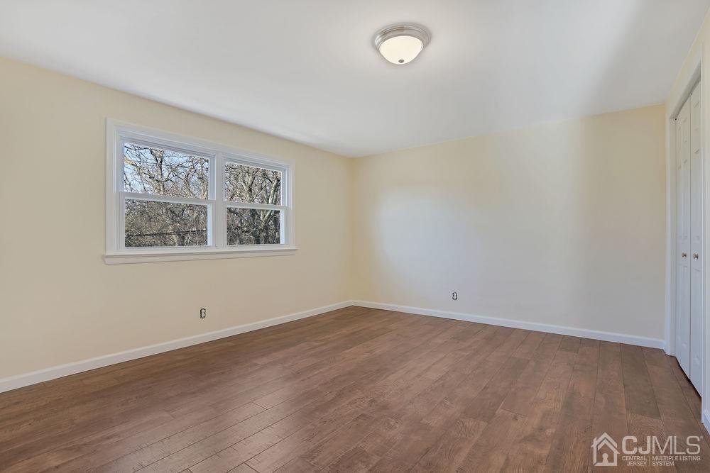 177 Old Post Road Edison, NJ 08817 - Photo 22 of 34 an empty room with wooden floor and window