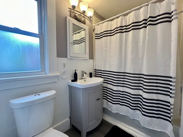 a bathroom with a sink a mirror and a shower curtain
