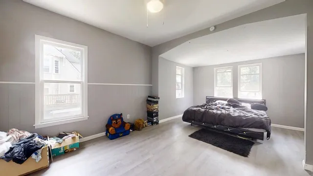 a living room with furniture toys and a window