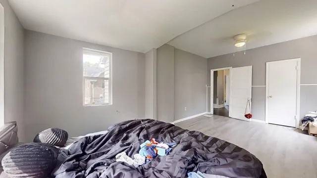 a bedroom with bed and a window