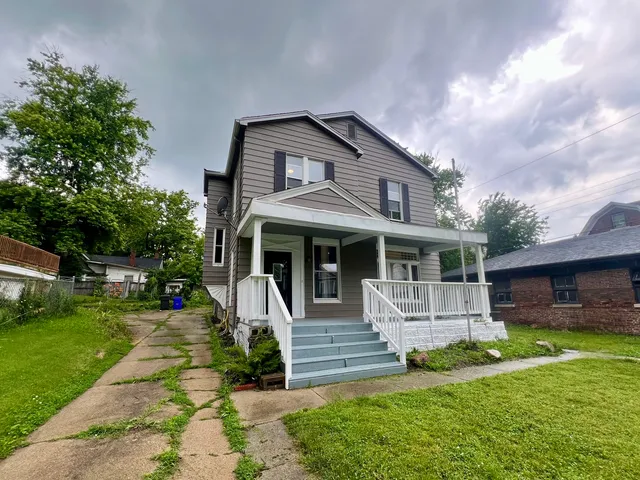 a front view of a house with a yard table and chairs