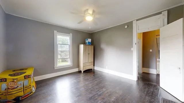 wooden floor in an empty room with a window