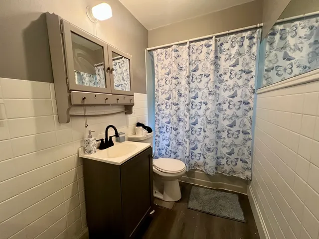 a bathroom with a sink toilet and shower