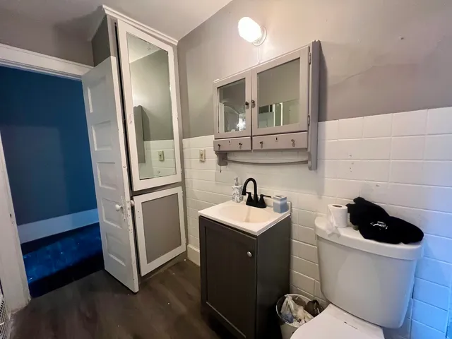 a bathroom with a toilet sink and mirror