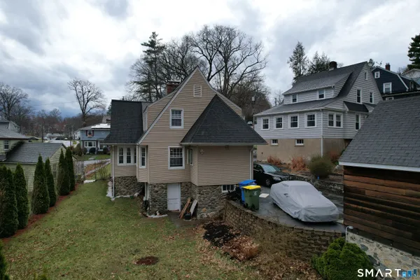 an aerial view of a house with backyard space and balcony