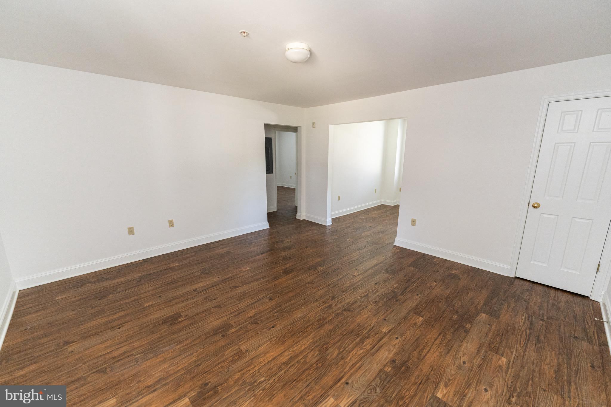 804 Travers Street, Unit 2 Cambridge, MD 21613 - Photo 5 of 26 a view of an empty room with wooden floor