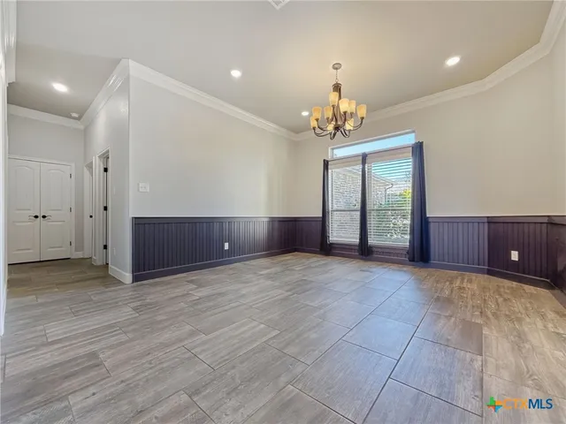 a view of an empty room with a chandelier