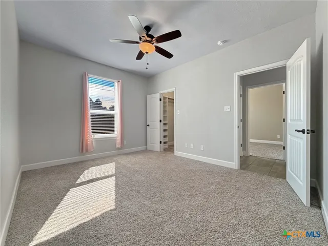 an empty room with closet and windows