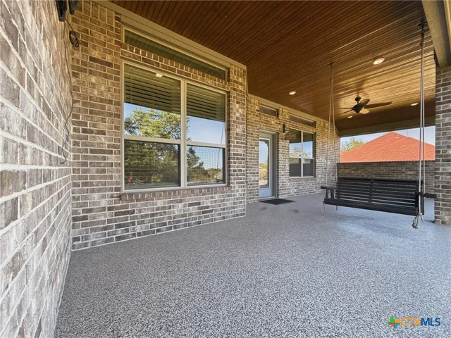 a view of an empty room with windows