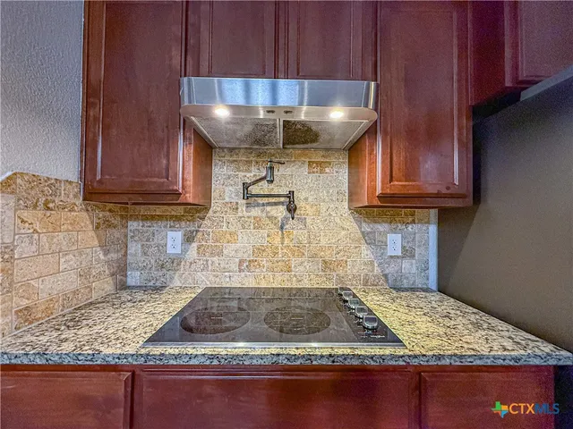 a kitchen with kitchen countertops and wooden cabinets
