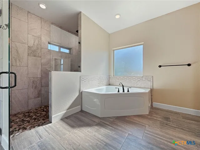 a bathroom with a bathtub and shower