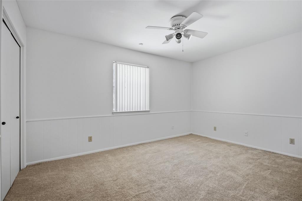 15721 Mapleview Circle Dallas, TX 75248 - Photo 16 of 40 an empty room with a chandelier fan