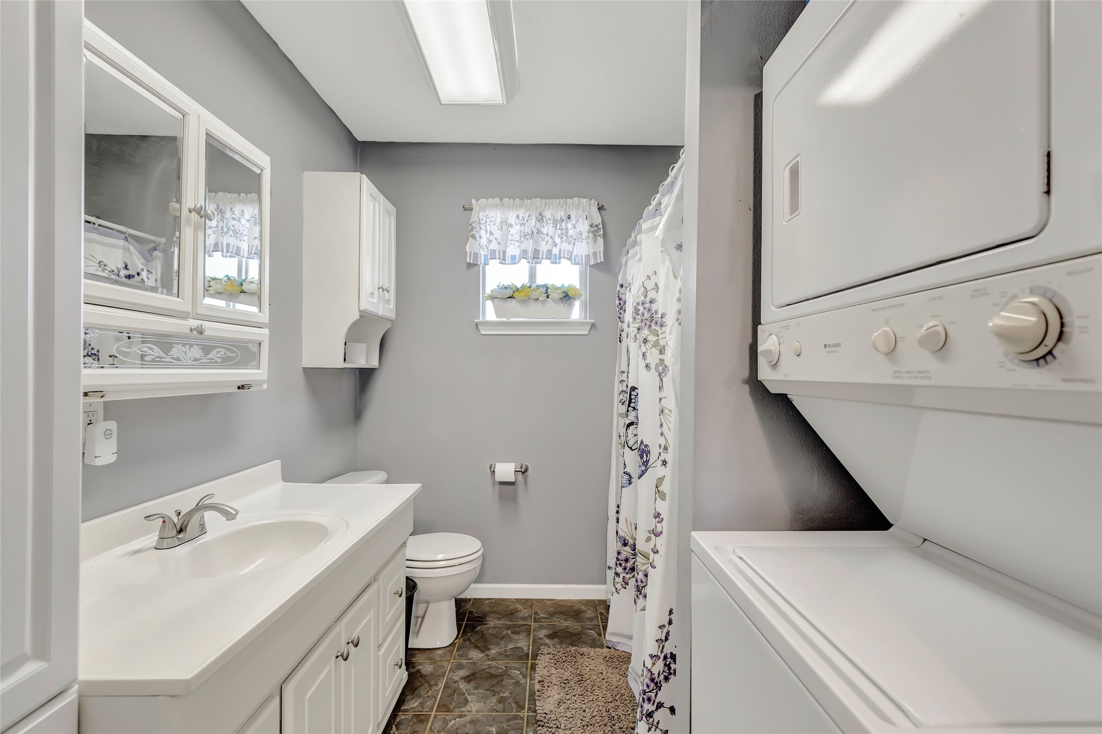 1014 North Rivershire Drive Conroe, TX 77304 - Photo 17 of 37 a bathroom with a sink a toilet and a mirror