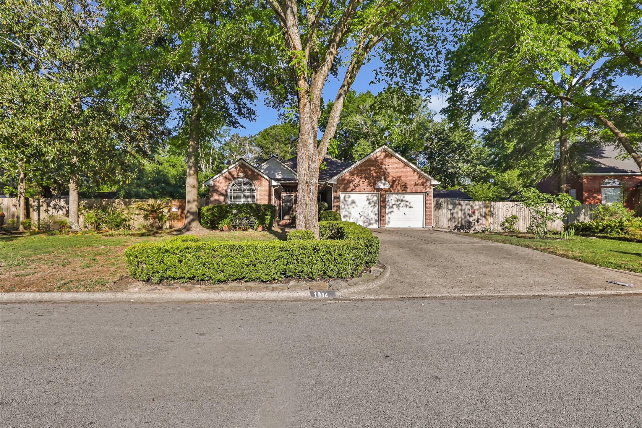 1014 North Rivershire Drive Conroe, TX 77304 - Photo 2 of 37 a front view of a house with a yard and garage