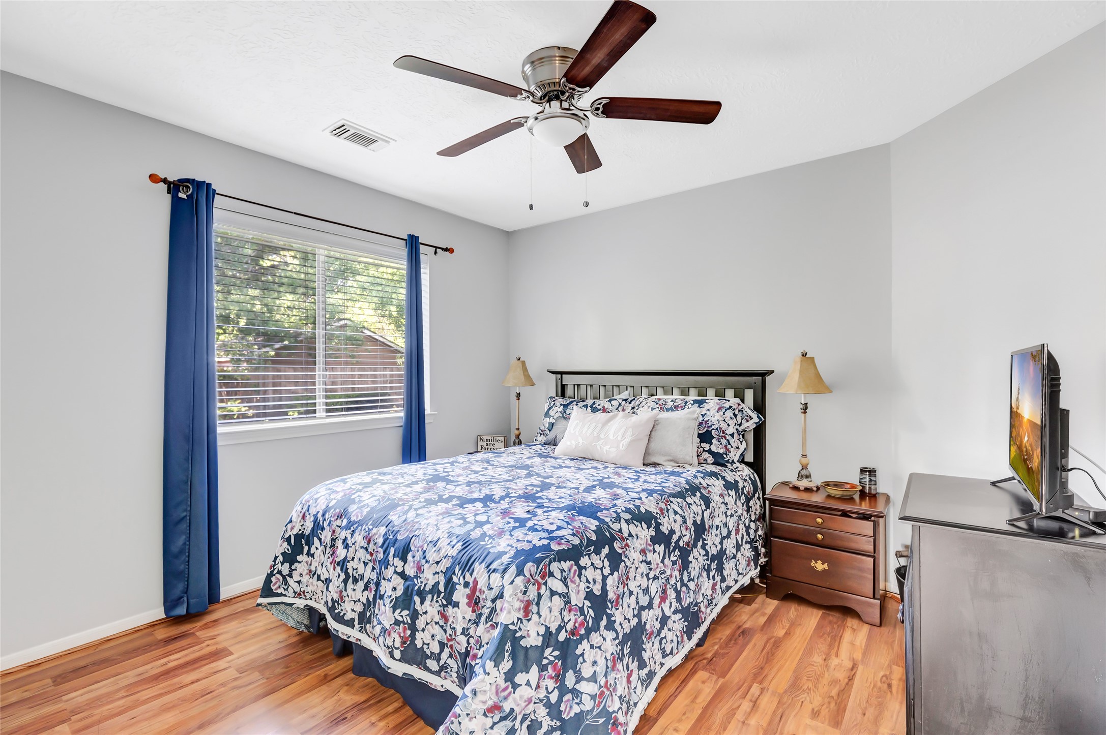 1014 North Rivershire Drive Conroe, TX 77304 - Photo 22 of 37 a bedroom with a bed and wooden floor