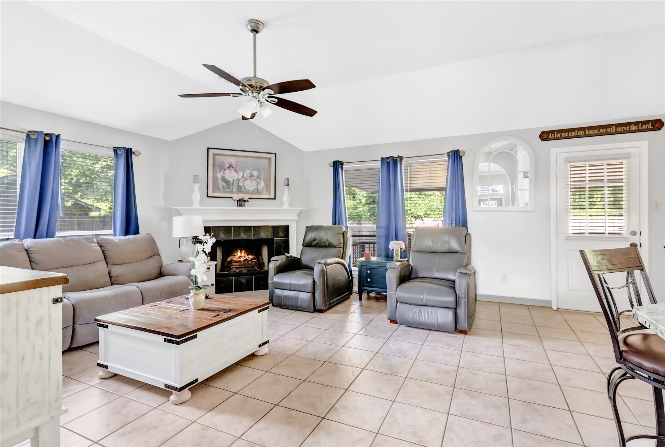 1014 North Rivershire Drive Conroe, TX 77304 - Photo 25 of 37 a living room with furniture a flat screen tv and a large window