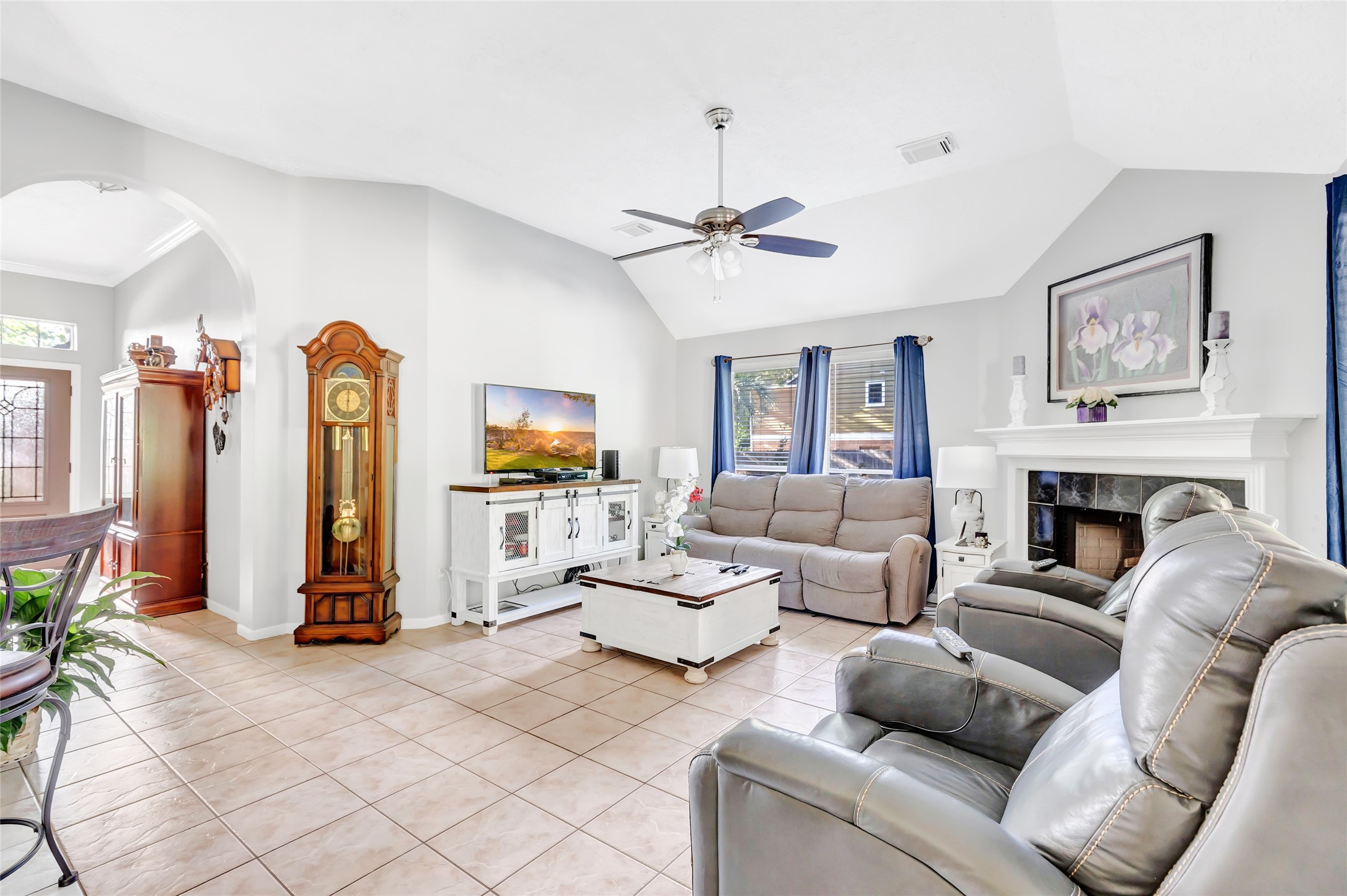 1014 North Rivershire Drive Conroe, TX 77304 - Photo 26 of 37 a living room with furniture a fireplace and a chandelier
