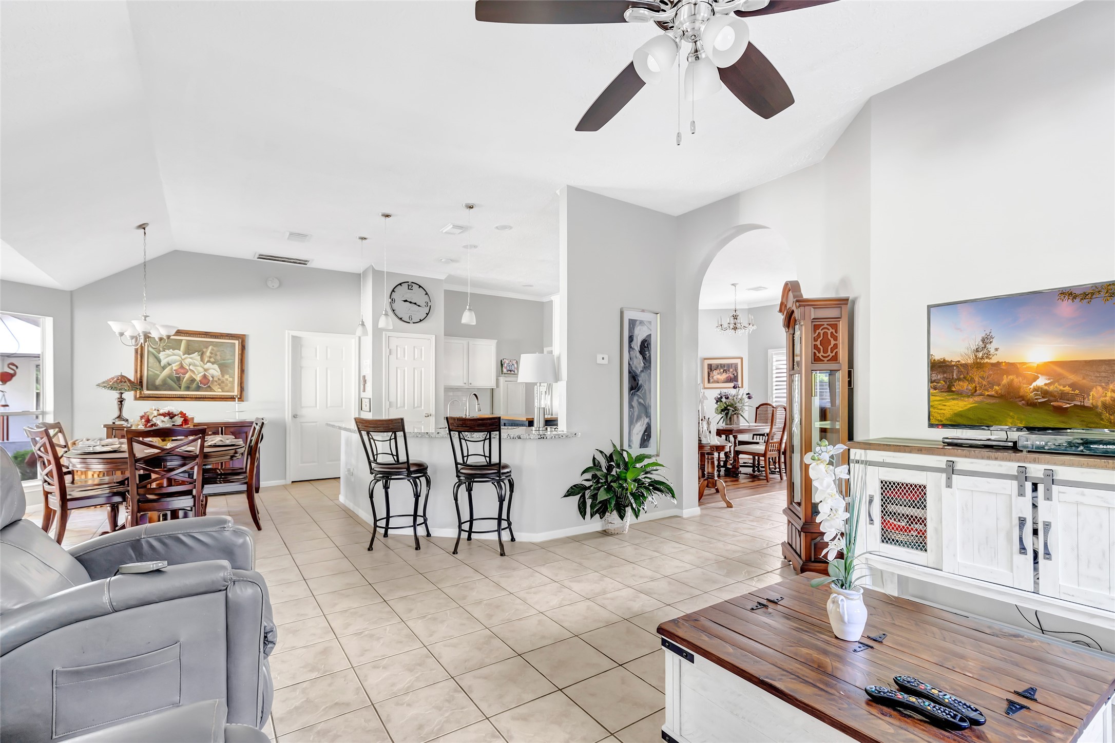 1014 North Rivershire Drive Conroe, TX 77304 - Photo 27 of 37 a living room with furniture a dining table and a potted plant