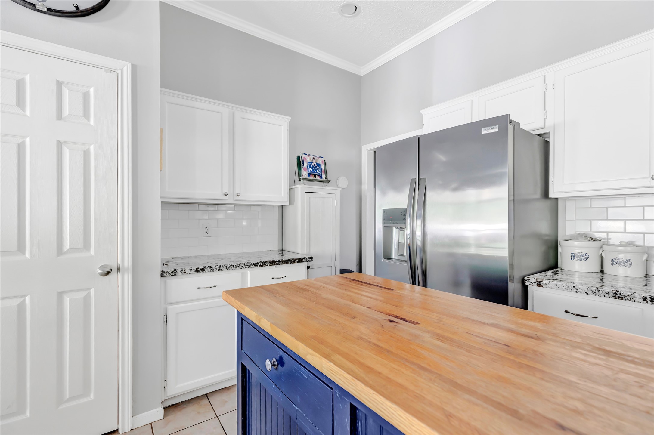 1014 North Rivershire Drive Conroe, TX 77304 - Photo 31 of 37 a kitchen with a refrigerator and a sink