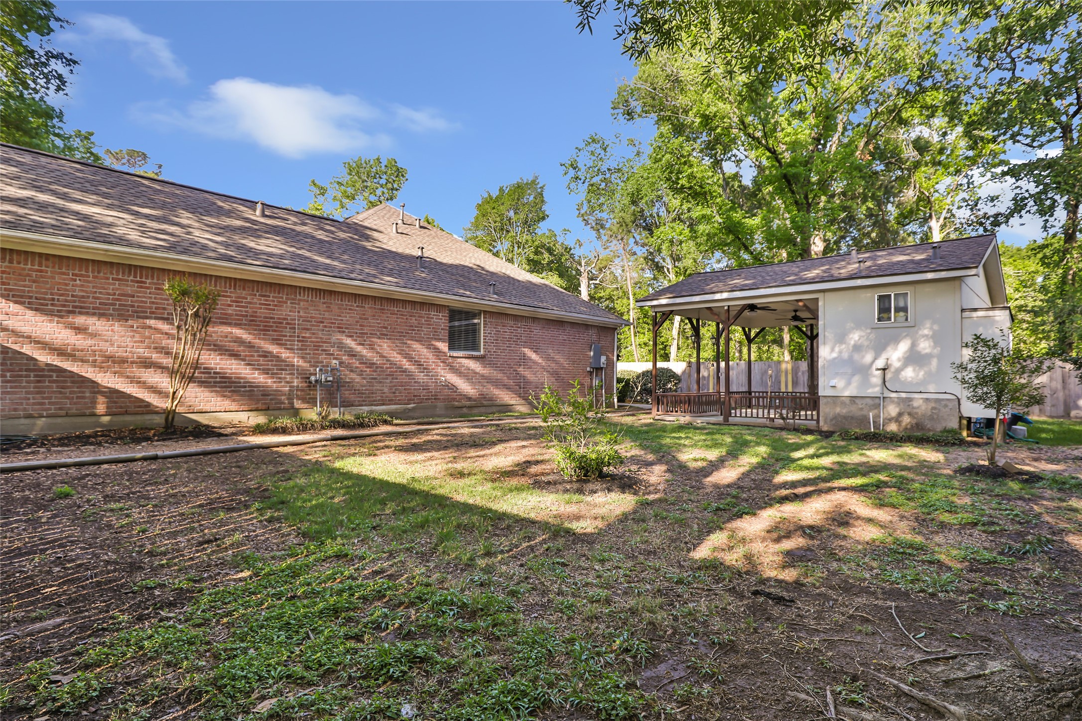 1014 North Rivershire Drive Conroe, TX 77304 - Photo 5 of 37 a view of a backyard with table and chairs and potted plants