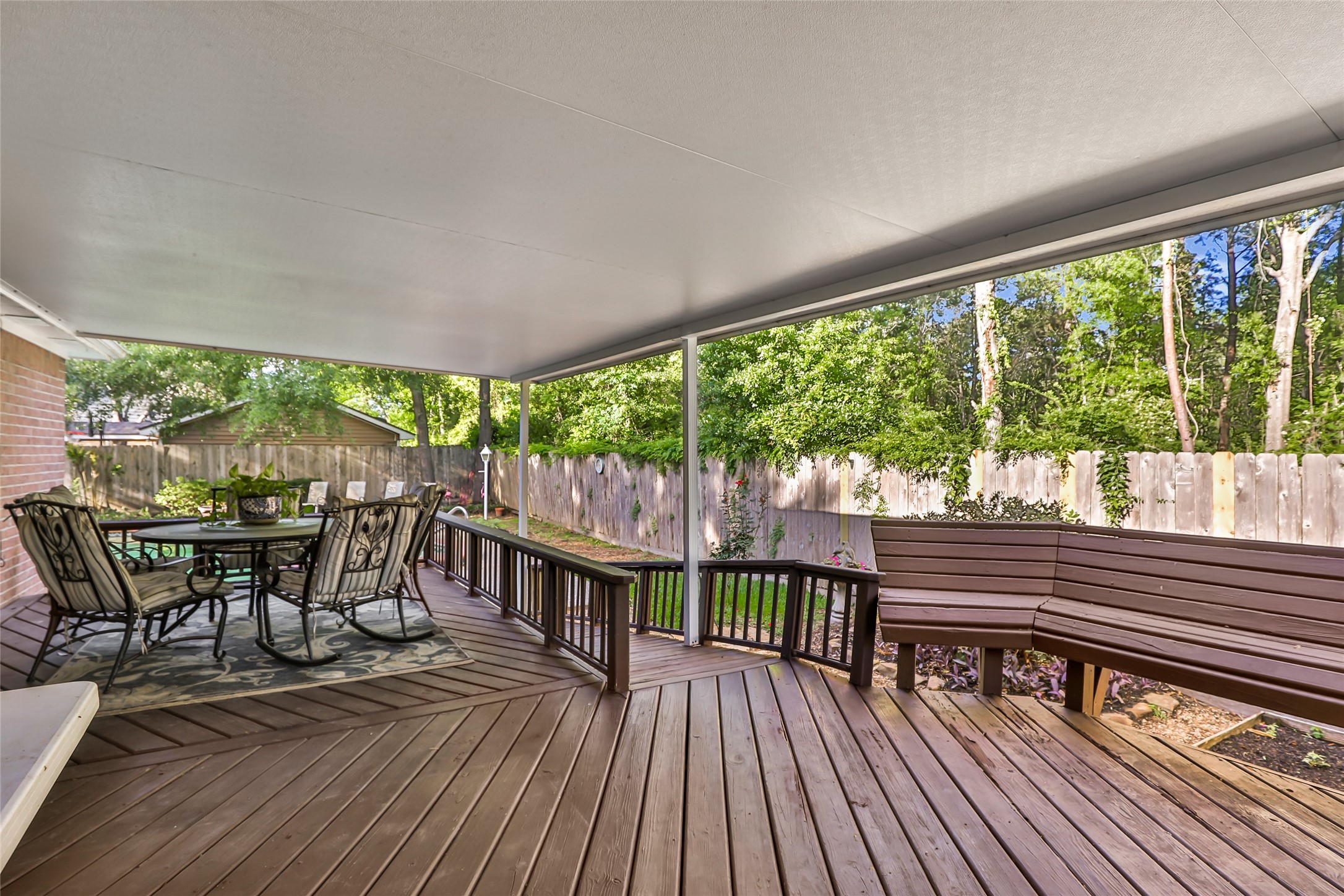 1014 North Rivershire Drive Conroe, TX 77304 - Photo 6 of 37 a view of a patio with a table chairs and a patio