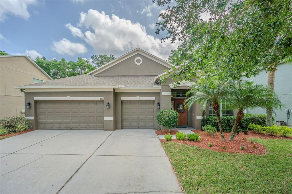 a front view of house with yard and green space