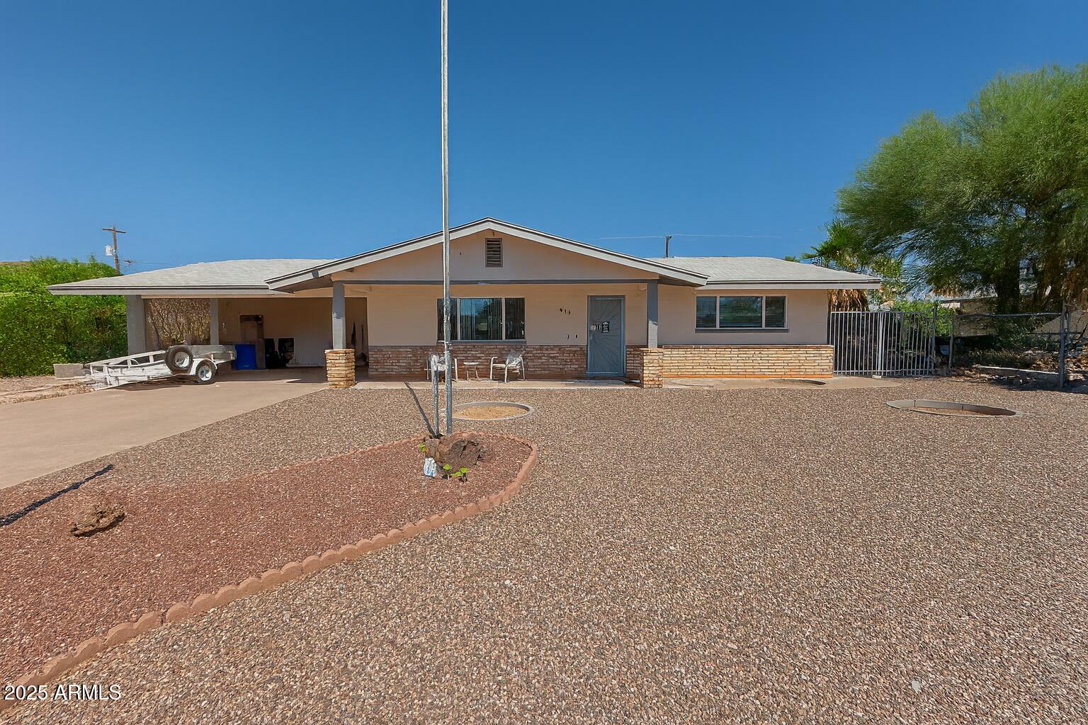 610 East Estevan Avenue Apache Junction, AZ 85119 - Photo 13 of 15 a front view of a house with a yard