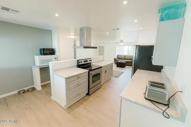 a kitchen with kitchen island white cabinets and white appliances