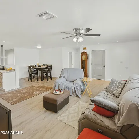a living room with furniture and kitchen view