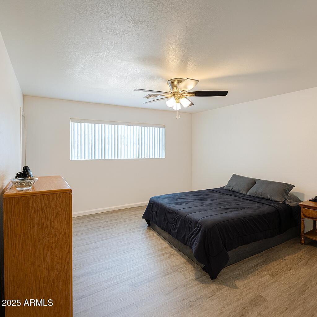 610 East Estevan Avenue Apache Junction, AZ 85119 - Photo 4 of 15 a bedroom with a bed and window