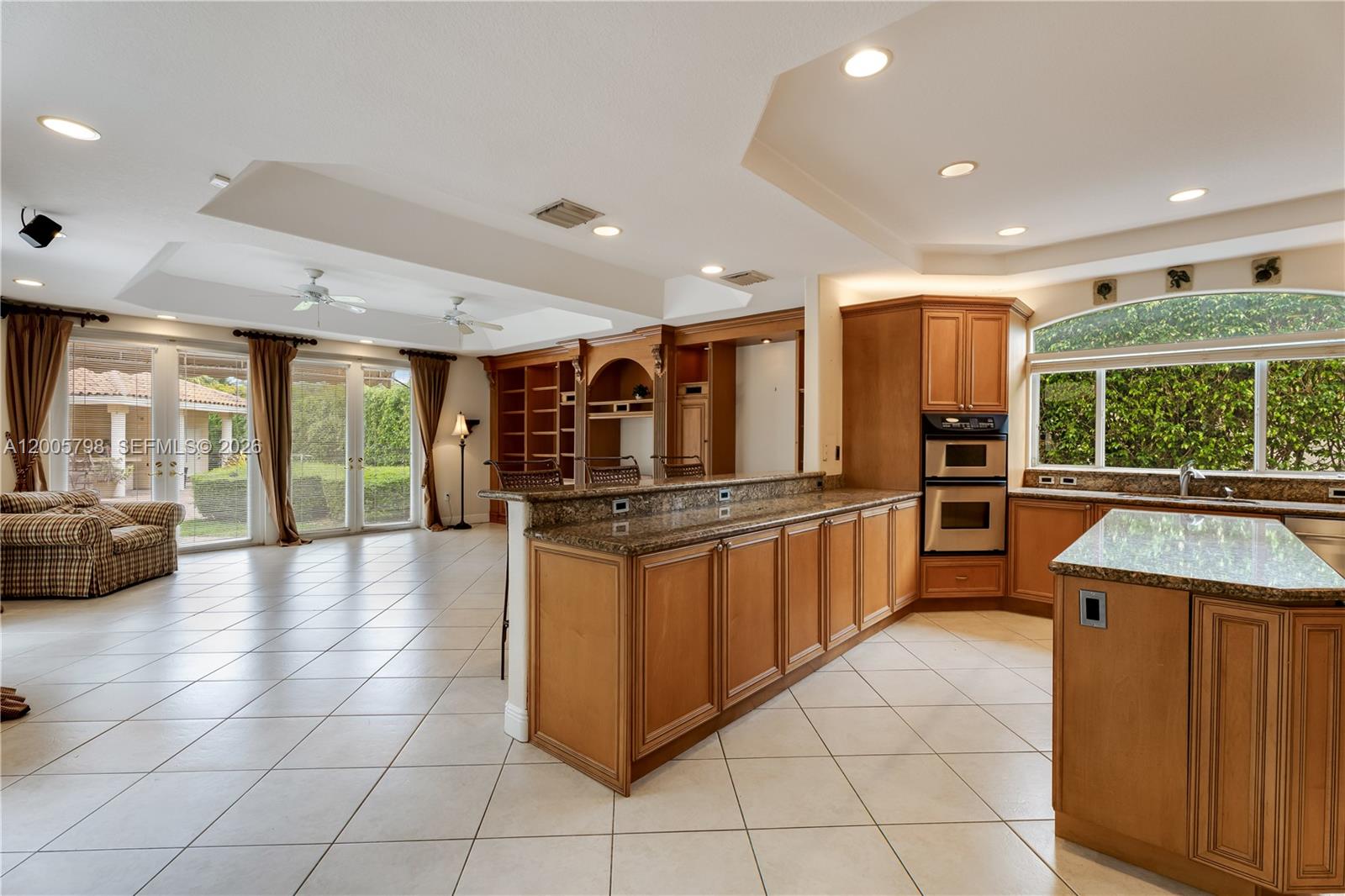 11071 Southwest 28th Street Miami, FL 33165 - Photo 11 of 78 a kitchen with stainless steel appliances kitchen island granite countertop a large counter top and a stove