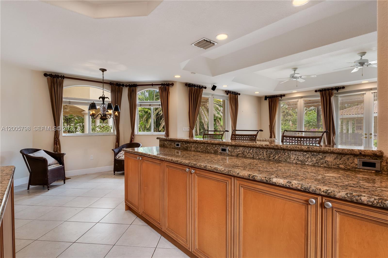 11071 Southwest 28th Street Miami, FL 33165 - Photo 17 of 78 a large kitchen with granite countertop a sink and a counter top space