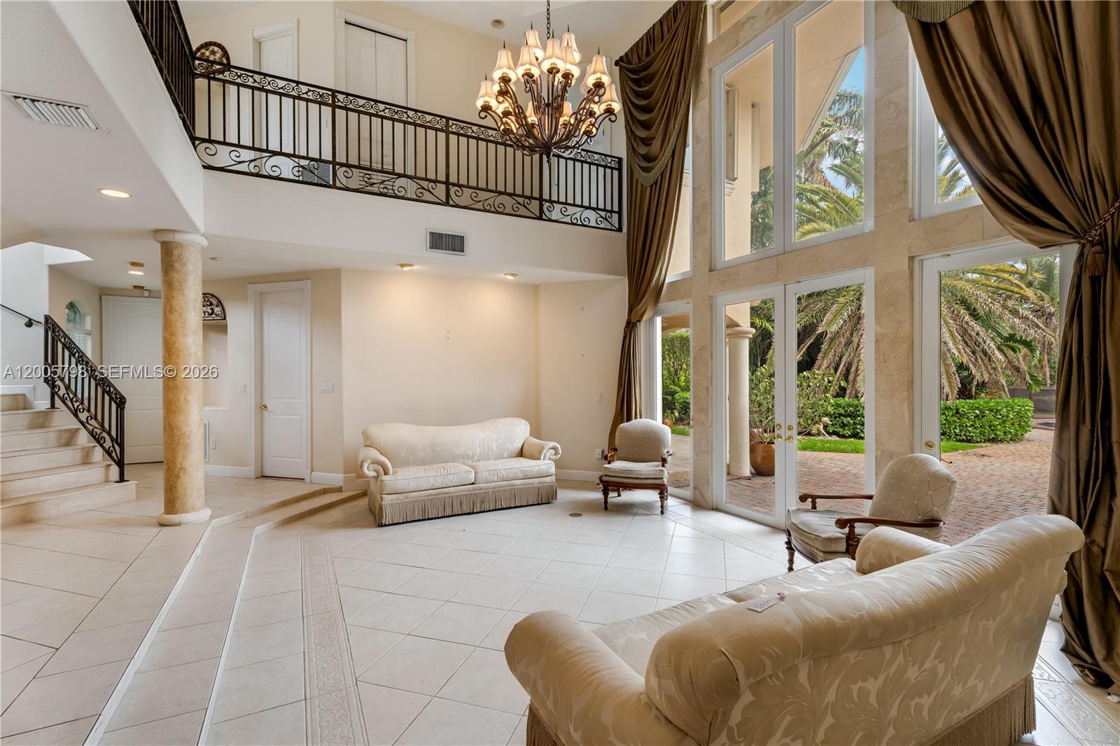 11071 Southwest 28th Street Miami, FL 33165 - Photo 2 of 78 a living room with furniture and a chandelier